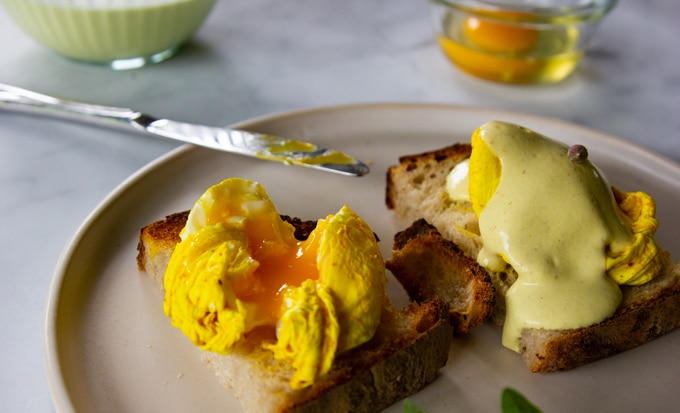 turmeric poached egg on toast with vegan hollandaise