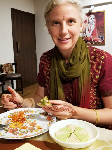 Westerner eating home-cooked Indian food in Mumbai