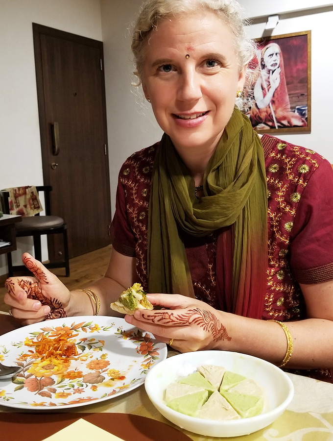 Westerner eating home-cooked Indian food in Mumbai, India.