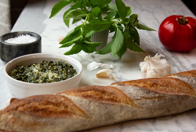 Basil pesto with a baguette, tomato, garlic and salt