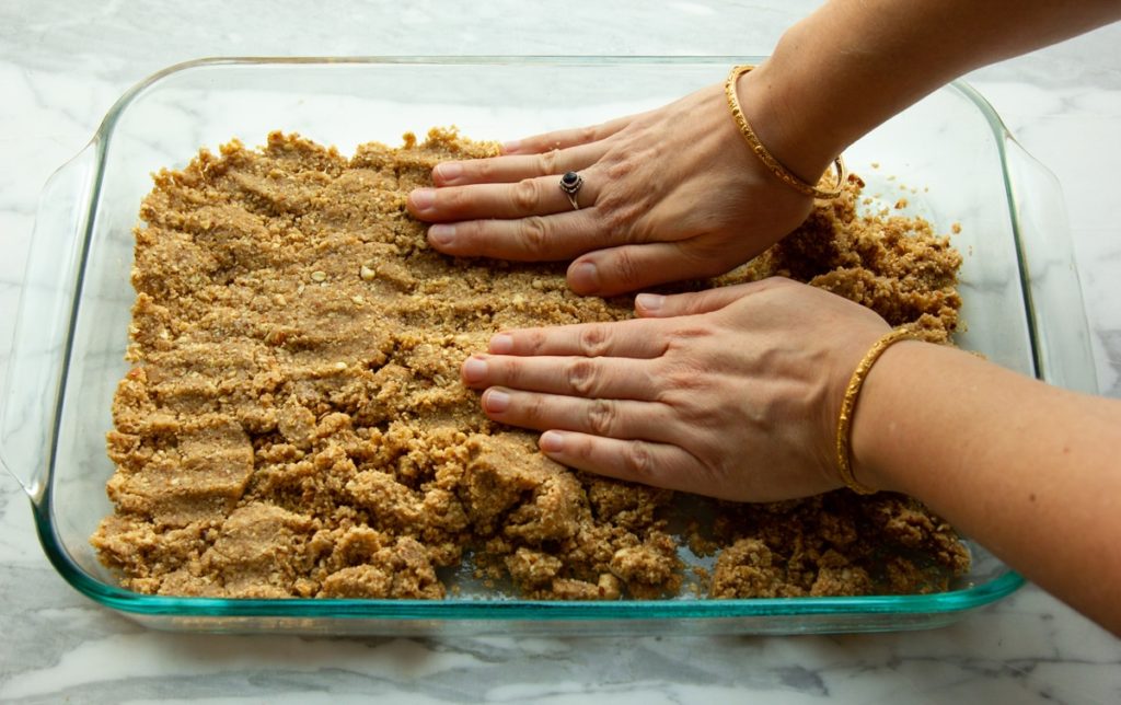 pressing the oat filling into the tray