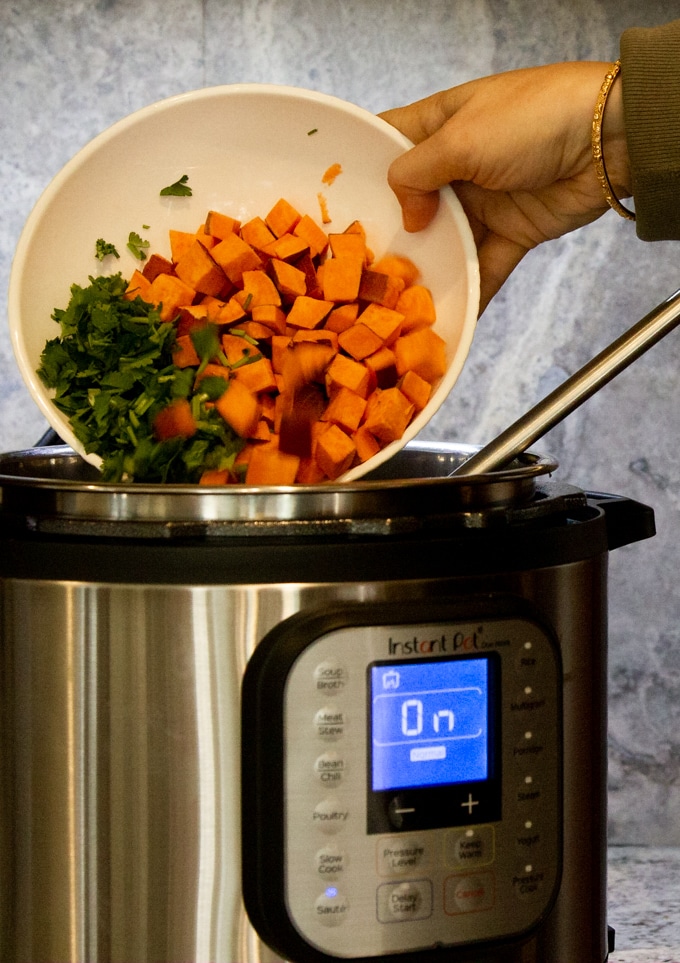 adding sweet potatoes to the instant pot