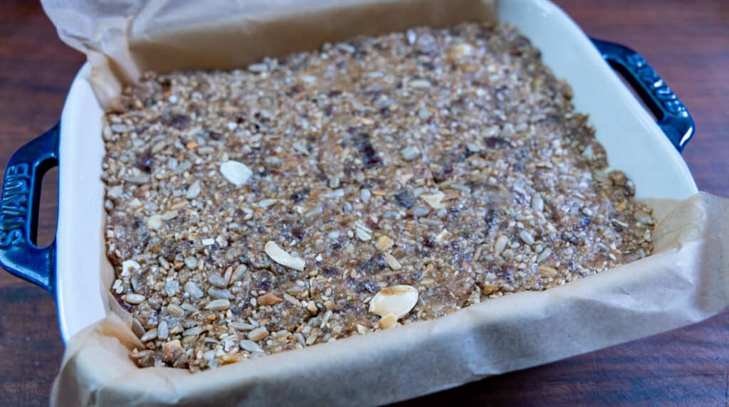 press sunflower seed mixture into tray